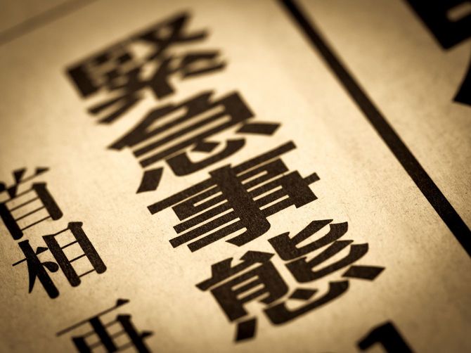 緊急事態の文字が新聞の見出しに