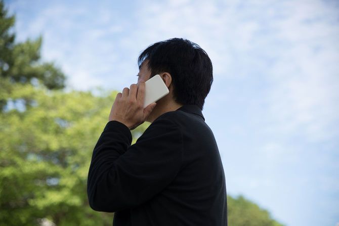 スマホで電話をする人物
