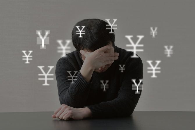 お金の問題に苦しむ男の画像