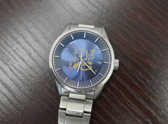 河越社長が身に着けている同社オリジナルの腕時計。「ツイてますか ツイてま～す」と書かれている