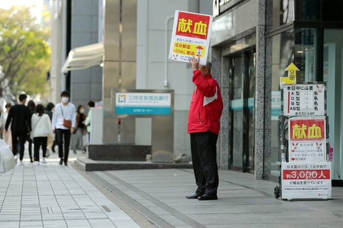 愛知県独自の「緊急事態宣言」が発令され、人通りの少なくなった中、献血を呼びかける男性＝2020年4月11日、名古屋市中区