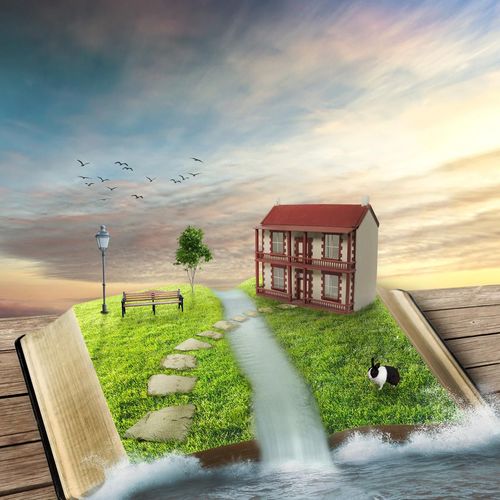 開いた本の上に家や川などの世界が広がっているイラスト