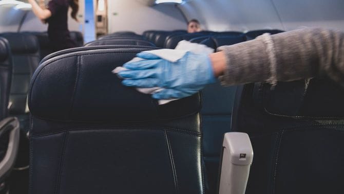 飛行機のシートを消毒している
