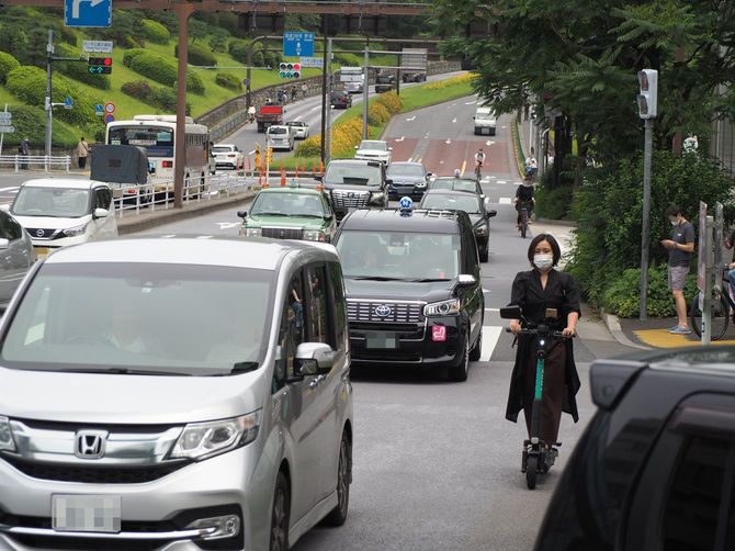 クルマの多い大通りを走行する電動キックボード