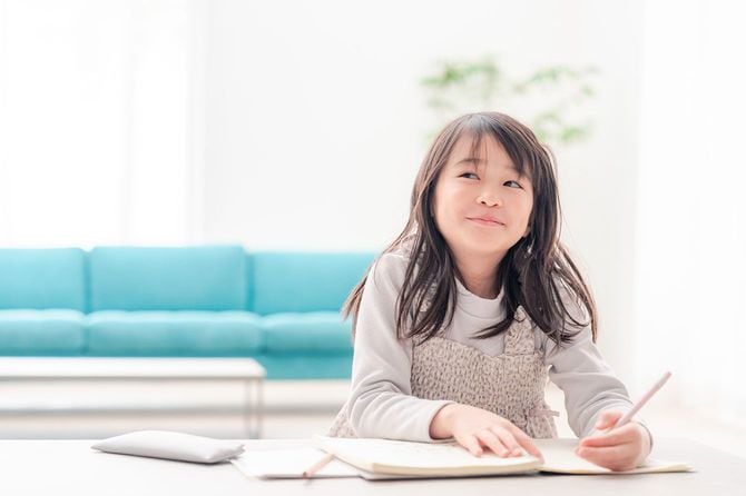 リビングルームで勉強をする子供