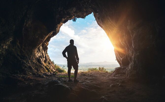 洞窟の出口に立つ男性