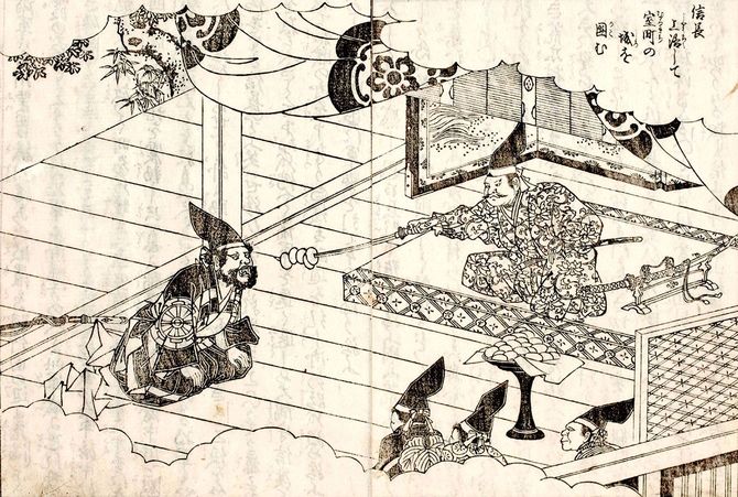 『絵本太閤記』二篇巻六/信長に刀に刺した餅を食わされる村重。