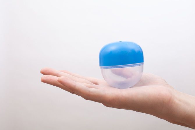 手のひらにのせたガチャガチャのカプセル