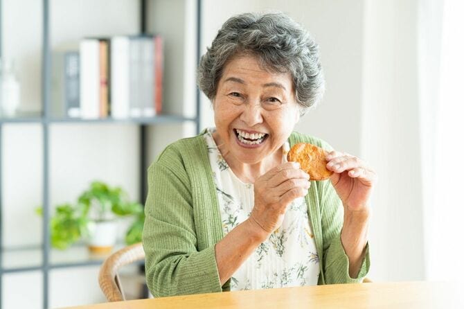 せんべいを食べる高齢女性