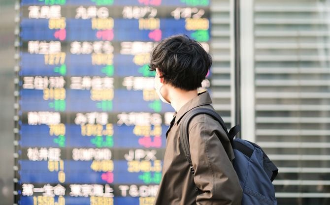 マーケット情報を見つめる若い男性