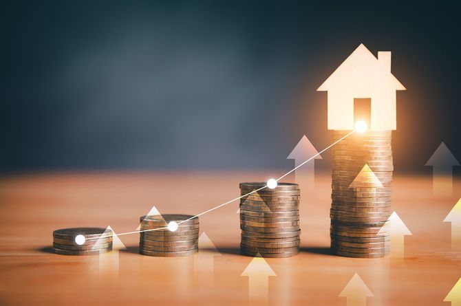 光る家のアイコンと上向きの矢印が付いたコインのスタック