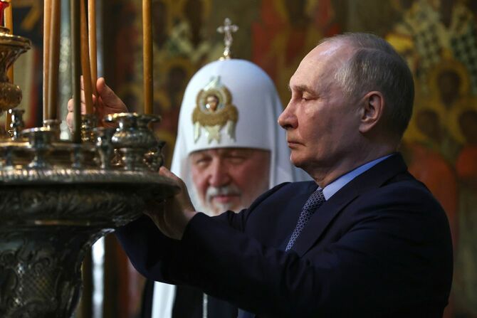 2024年6月26日、ロシア、モスクワ地方セルギエフ・ポサードにある至聖三者聖セルギイ大修道院を訪問し、ロウソクを立てるウラジーミル・プーチン大統領（右）とモスクワ・全ロシア総主教キリル
