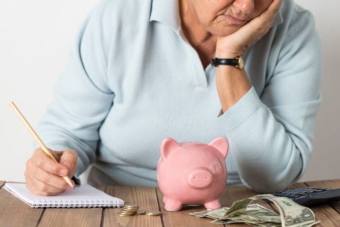 貯金を計算して落ち込む老人