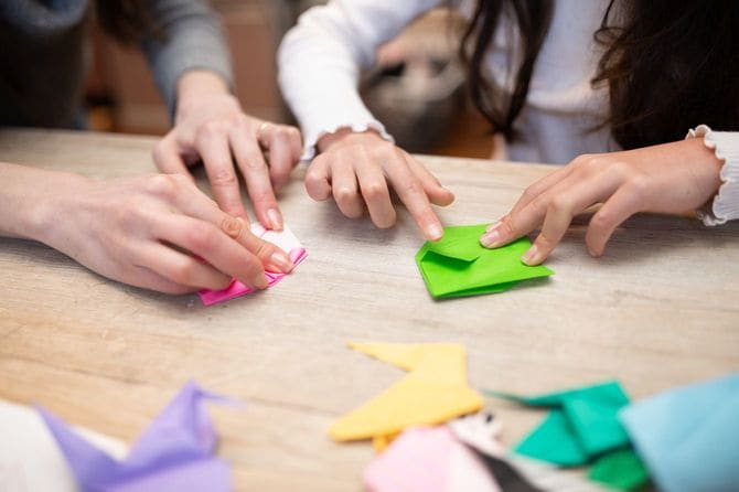 一緒に折り紙で遊ぶ母と子