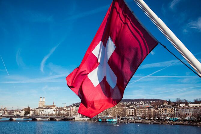 チューリッヒ湖を背景にはためくスイスの国旗