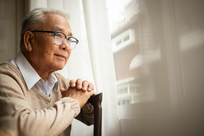 窓の外を見ている老人