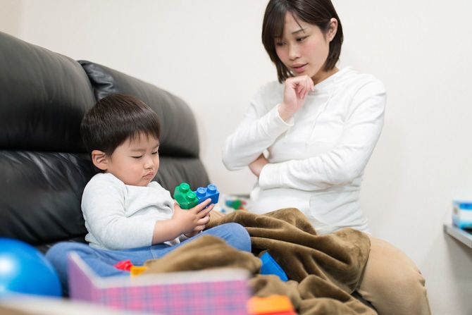 困ったように子供を見つめる母親
