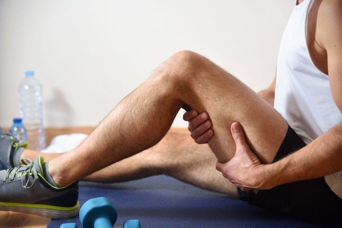 太もも裏の筋肉を抑えるストレッチ中の男性