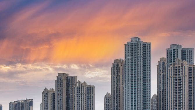 夕焼けを背景にした新興住宅地のビル群