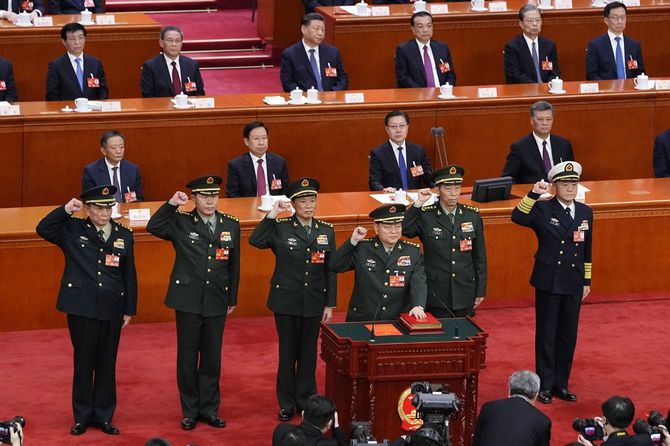 中国全人代の全体会議で宣誓する張又俠・中央軍事委員会副主席（手前左から4人目）。最後列左から3人目は習近平国家主席＝2023年3月、北京の人民大会堂（共同）