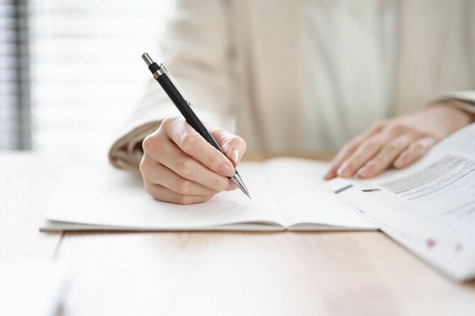 机で勉強する人の手