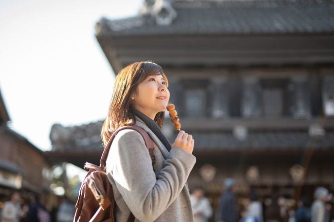 日本の伝統的なレトロスタイルの町で一人旅をする女性