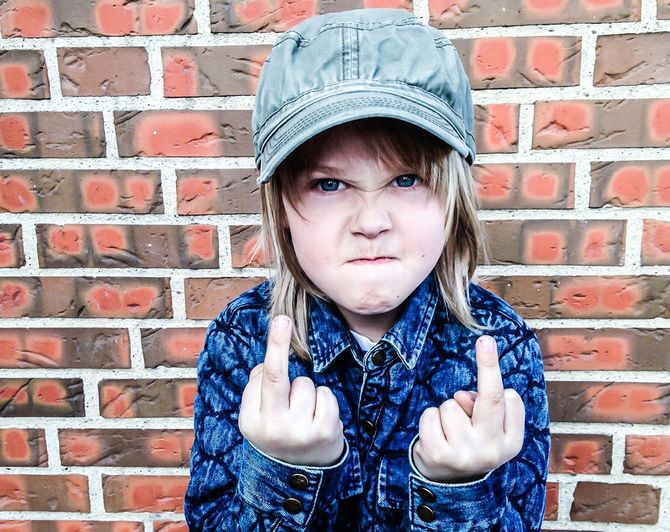 Boy making obscene gesture