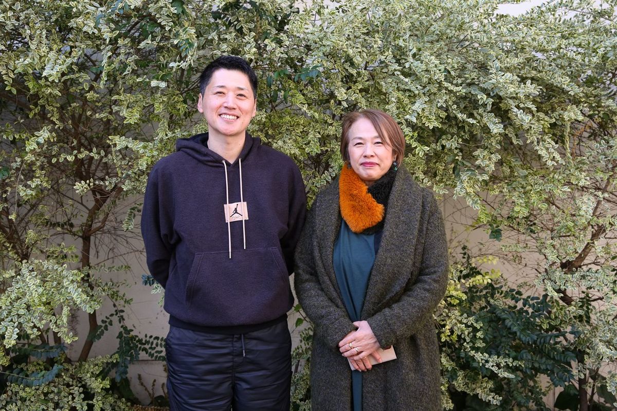 撮影に応じる恩塚亨HC（左）と、ジャーナリストの島沢優子さん（右）
