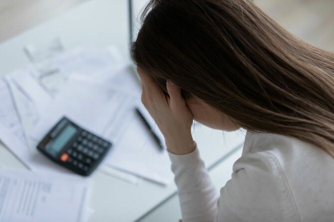 財政上の問題を抱える女性、計算した後、絶望を感じている