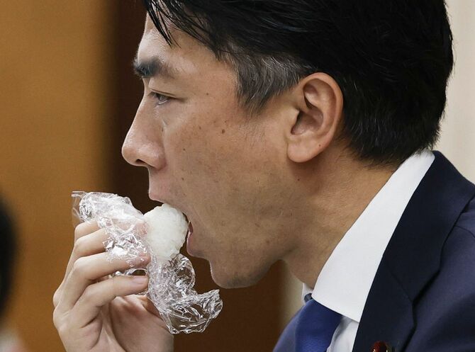 備蓄米の試食会に参加し、おにぎりを口にする小泉農相＝2025年5月29日、農水省