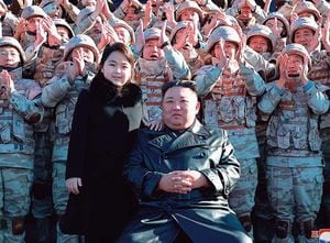新型ICBM級「火星17型」の試射に貢献した兵士らと記念撮影する金正恩総書記と娘。
