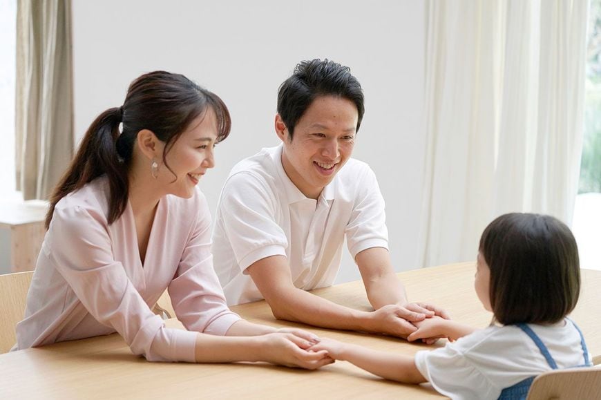 自宅で子供と話す両親