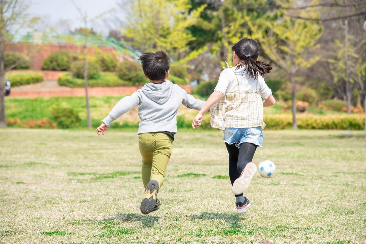 公園でサッカーをしている日本の子どもたち