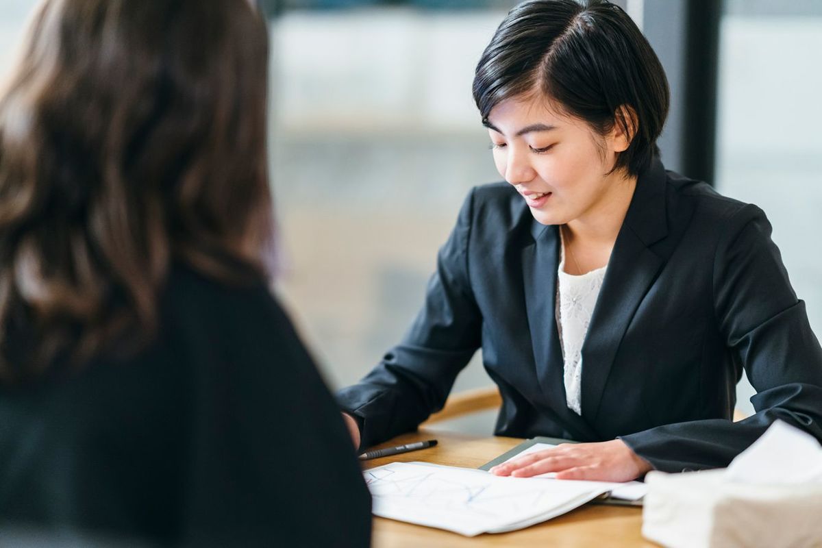 女性クライアントの話を聞く女性ビジネスパーソン