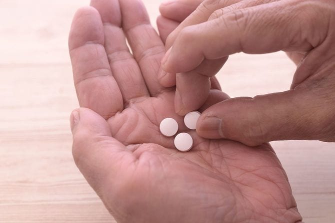 老人の手と錠剤