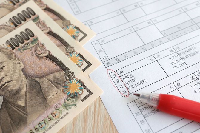 源泉徴収の書類と複数枚の一万円札